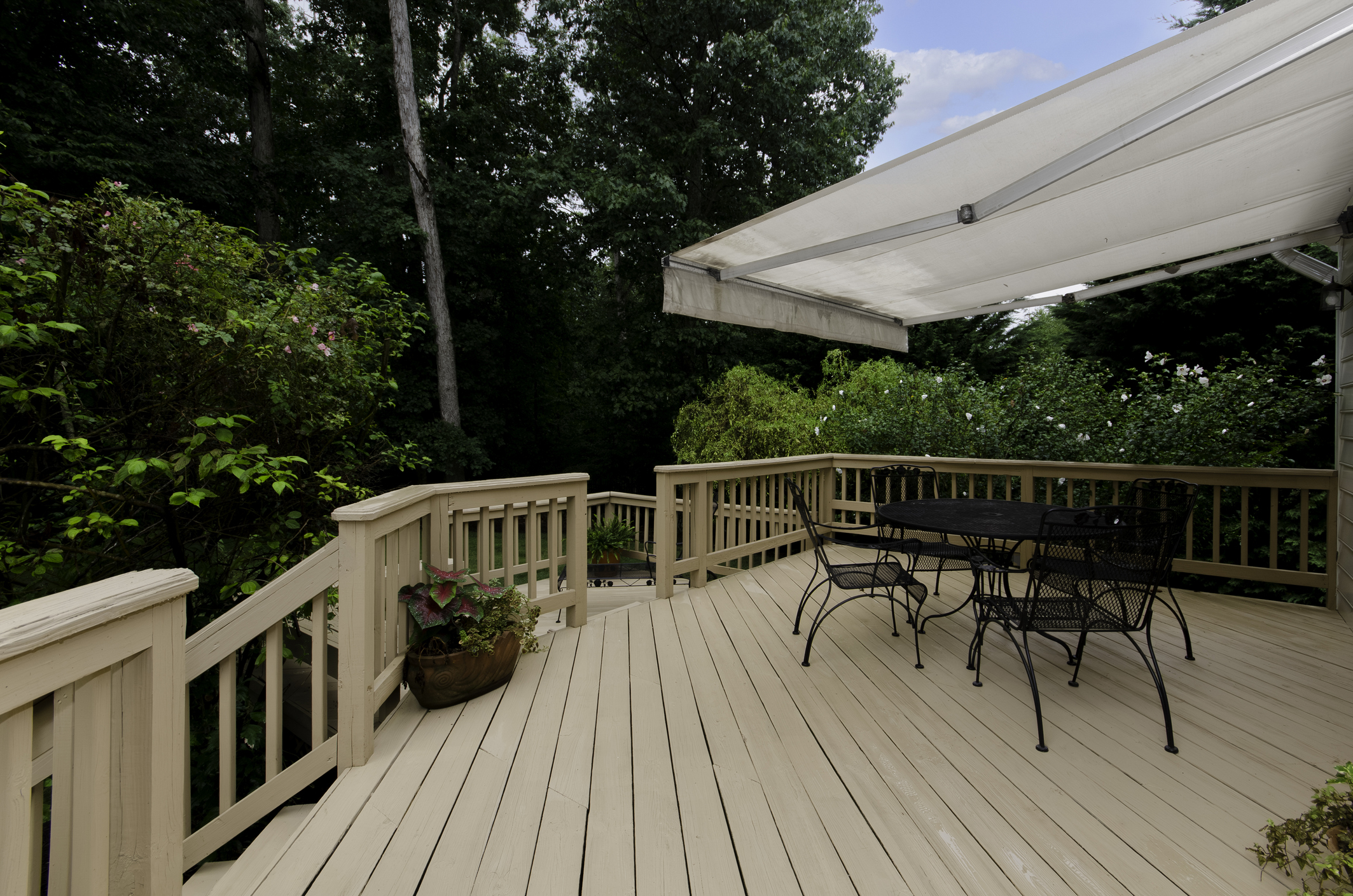 Composite deck with retractable awning and seating